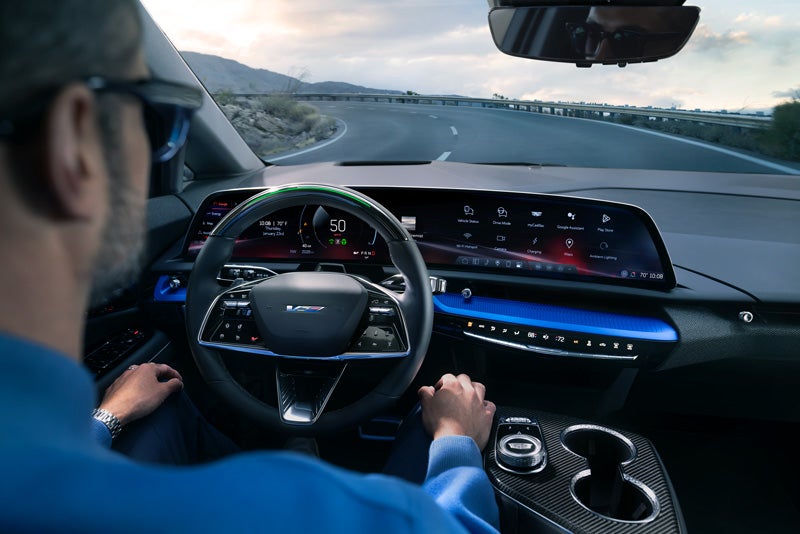 Front View of the 2026 OPTIQ-V Driving Through the Dusk Utilizing its Headlights | Ed Martin Cadillac in ANDERSON IN